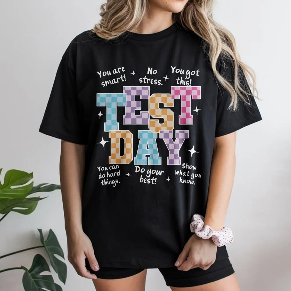 Model wearing a black t-shirt with a Test Day retro motivational print