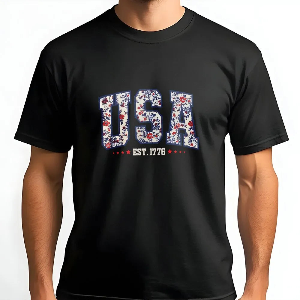 Man wearing a black unisex cotton t-shirt with a floral USA Est. 1776 print